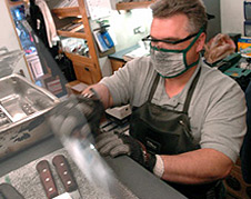 Rolling Sharpening Stone franchisee-owner Kent Palmerton sharpens knives in special chain mail gloved designed by Darryl Hoffman